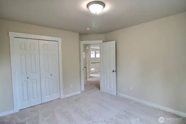 Another view from inside the back bedroom shows the closet and looks out the the landing.