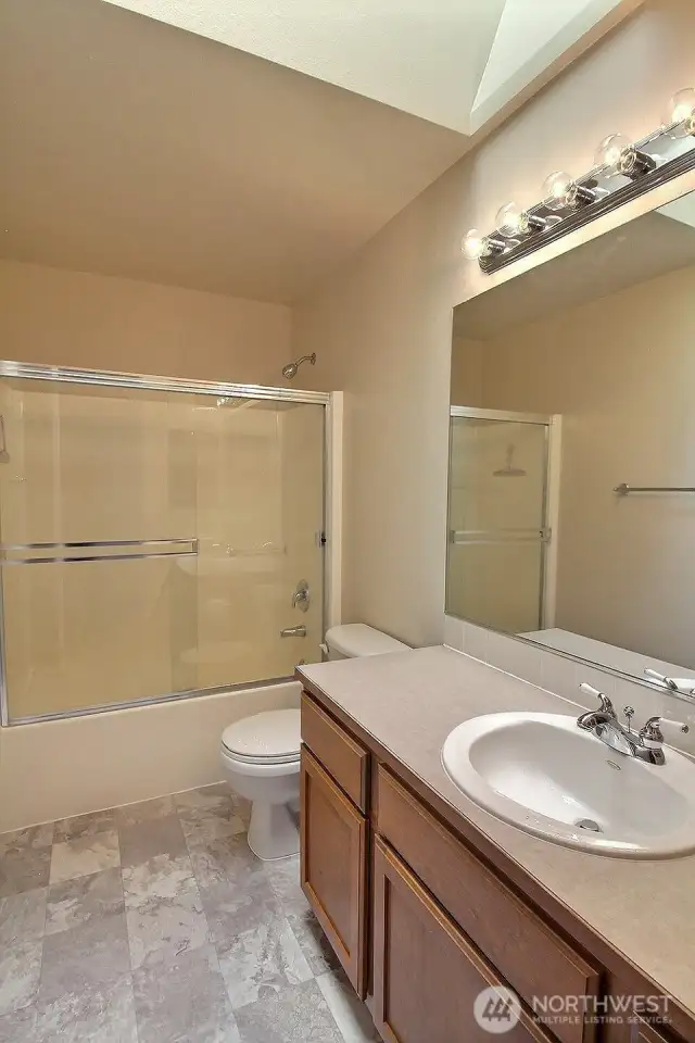 Upper level full bathroom has new flooring and large skylight.