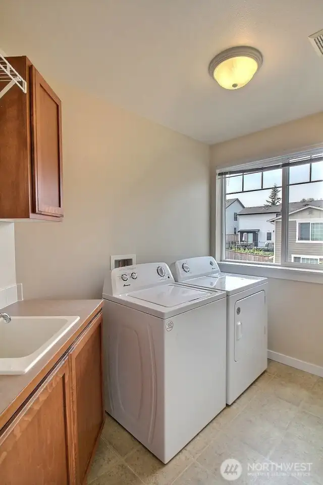 Large laundry is conviently located on the second floor and offers sink, cabinets and shelf too. Washer and Dryer stay adding value.