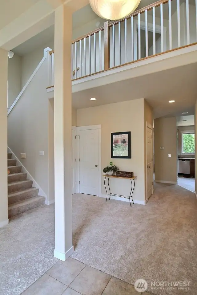 Step into the open, stylish feel of this home! Gorgeous railing, high ceilings, bright white trim, rounded corners and more!