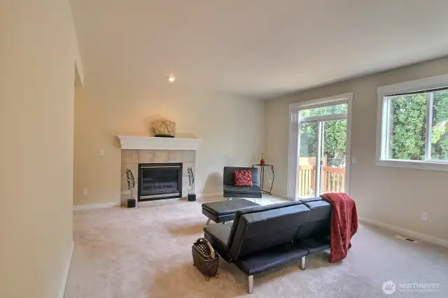 Sizable Family room with a cozy fireplace and crisp white mantle.