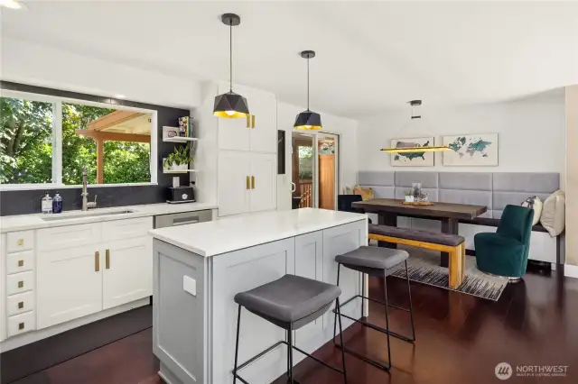 This stylish dining nook features custom built-in bench seating, a rustic wood table, and plush velvet chairs for a cozy yet modern vibe. Sliding glass doors open to a covered patio, extending your entertaining space outdoors. A perfect blend of comfort and function.