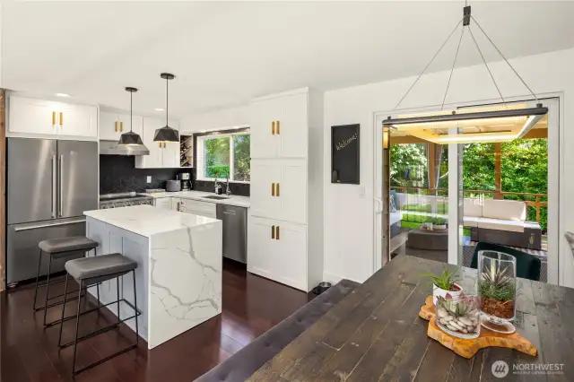 A sunny breakfast nook nestled by a large window makes mornings inviting, while durable flooring and generous cabinet storage provide both practicality and beauty in this culinary hub of the home....