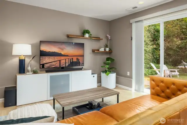 Enjoy expansive views and natural light through oversized windows in this open living area. Vaulted ceilings and a sleek spacious feel, while the neutral color palette and high-end finishes create a contemporary yet cozy atmosphere for everyday living....