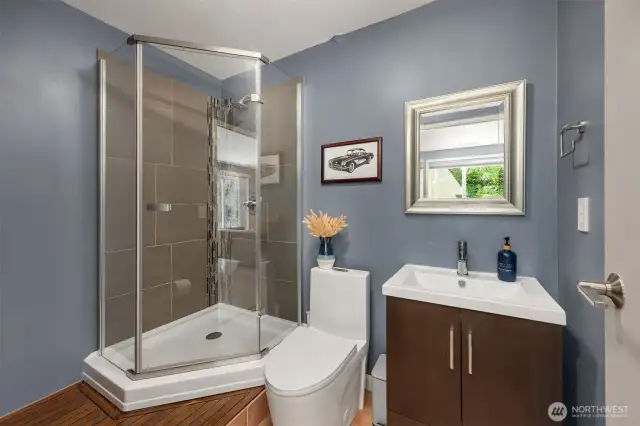 A convenient lower-level ¾ bath includes contemporary finishes, a large step-in shower with sleek glass doors, and elegant tile work—perfect for guests, multigenerational living, or private home office access....