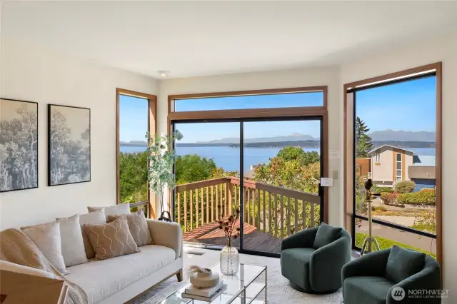 Formal dining & living facing Western Sound & Mountain Views, opening to deck