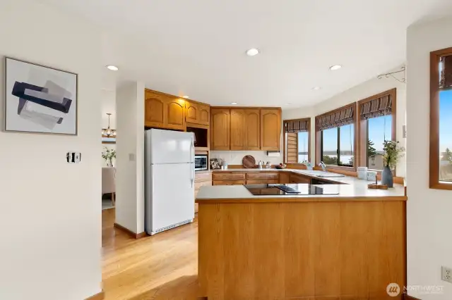 Open kitchen w/ Sound views, casual dining area & den