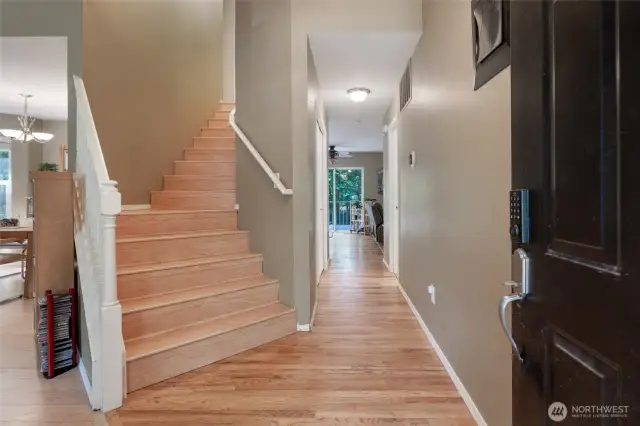 Upon entering you are greeted by a wide staircase, looking straight down the hallway into the den. On the left is the formal living room and dining room with an entrance into the kitchen.
