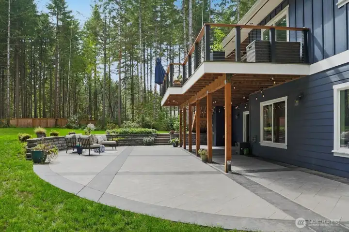 This luxurious patio could be a picture in Sunset Magazine.  The curved rockery wall has a stub... ready for your hot tub.  Beautifully designed with lighting.