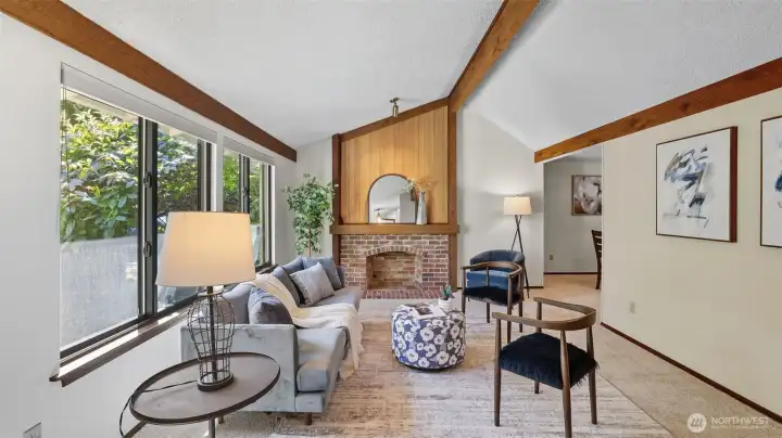 Enjoy this Sun-filled space framed by large windows and cozy brick fireplace.