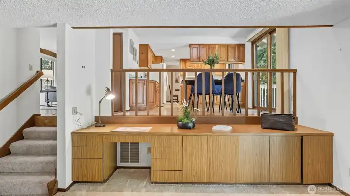 Dedicated desk area provides extra storage and workspace.