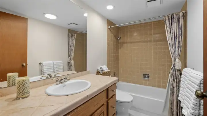 Spacious secondary bathroom upstairs with tub and shower combo and plenty of counter space.