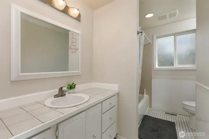 Main full bathroom with storage space and new paint!