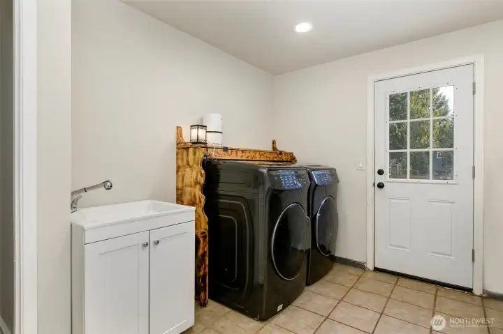 Large laundry and utility room. Leads out to patio and fenced backyard.