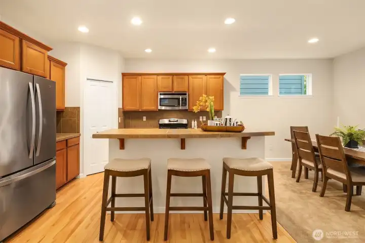 Kitchen has stainless steel appliances and additional island seating.