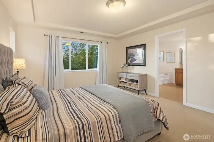 En suite bathroom and walk-in closet just a few steps away.