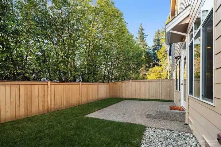 Backyard has nice lawn area and patio perfect for outdoor dining or barbecuing.