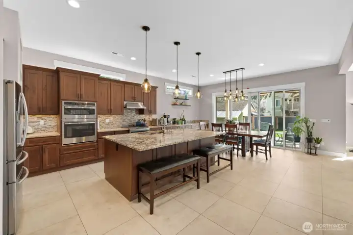 Beautiful kitchen with eating space and island with sink.