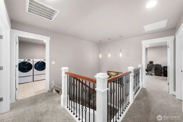 Upper landing with open railing and flexible transition space.