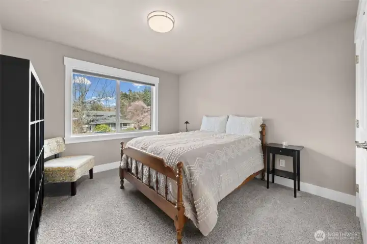 Spacious bedroom with large window and soft natural light. Connected to jack and Jill bathroom.