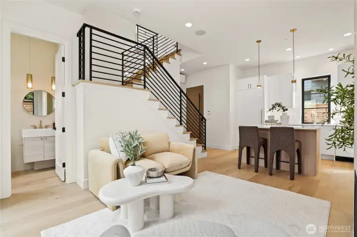 Open Staircase with Hardwood Floors and Custom Metal Railings