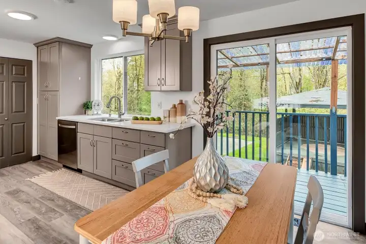 A sliding door leads to the covered deck—perfect for enjoying your morning coffee while taking in the serene setting.