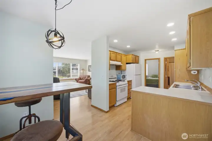 From patio access door through dining area with view into kitchen and living room