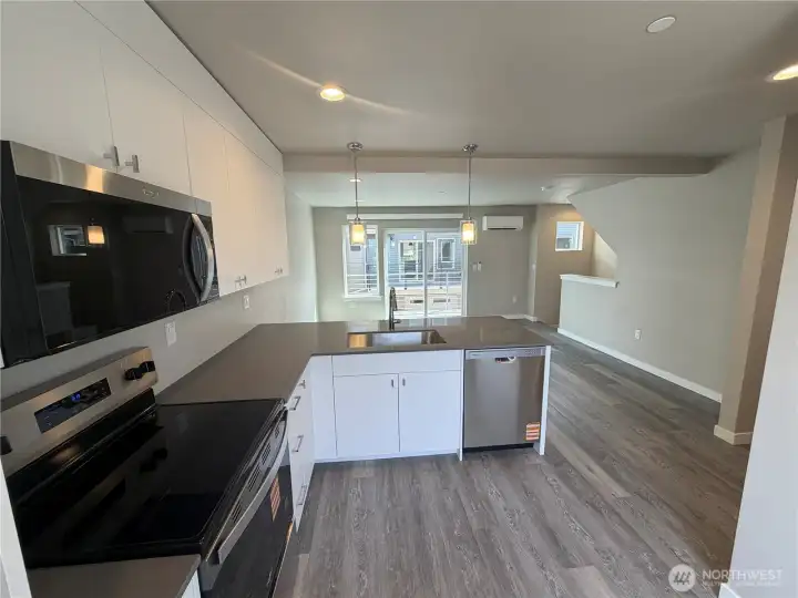 Photo of subject property. Kitchen look toward living area