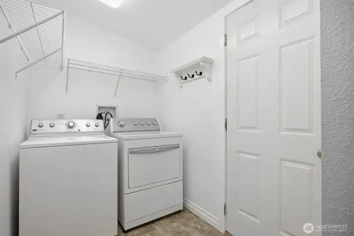 Laundry room off the kitchen with a door to the attached garage. Laundry room off the kitchen with a door to the attached garage.