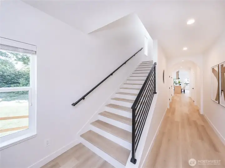 extra wide staircase and arched hallway