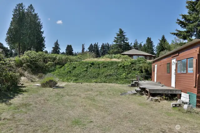 Good perspective. You are standing on the lower level of the lot looking up at the upper level of the lot. The house on Lot 1 is viewed in the distance. You are facing west in this photo.