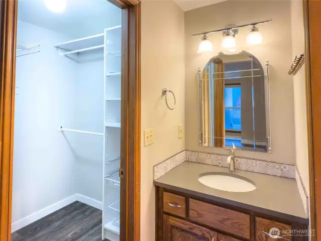 Convenient ensuite bath with vanity and walk-in closet access