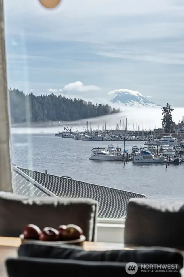 Mt Rainier is starting to poke out from morning fog.