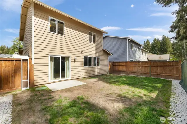 Backside of the house with potential has a great deck with built-in seating, fireplace, and a hot tub that’s a great place to relax at the end of a long day!