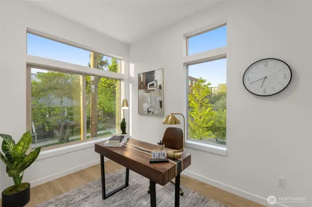 Surrounded by natural light and treetop views, this flex room is the perfect WFH setup or reading retreat.