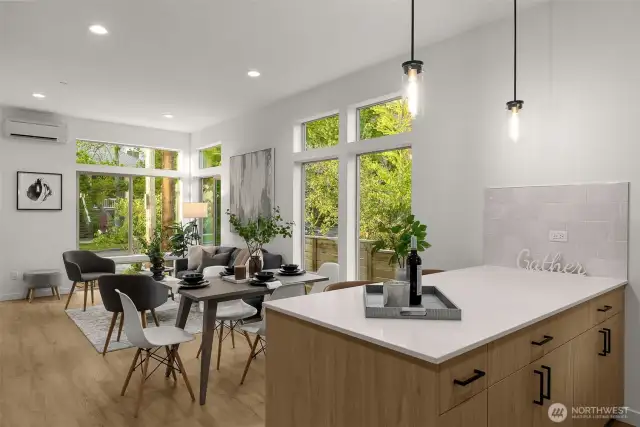 The thoughtful flow between the island, dining area, and windows creates the home's functional yet welcoming heart.