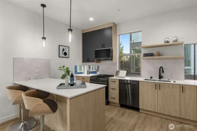 Chef's kitchen with personality — From sleek matte-black cabinetry to floating shelves and quartz countertops, this space blends style and functionality.