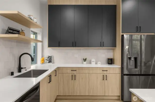 Storage that doesn't compromise style — Floor-to-ceiling cabinets, designer backsplash, and bold finishes keep your kitchen looking sharp and feeling organized.