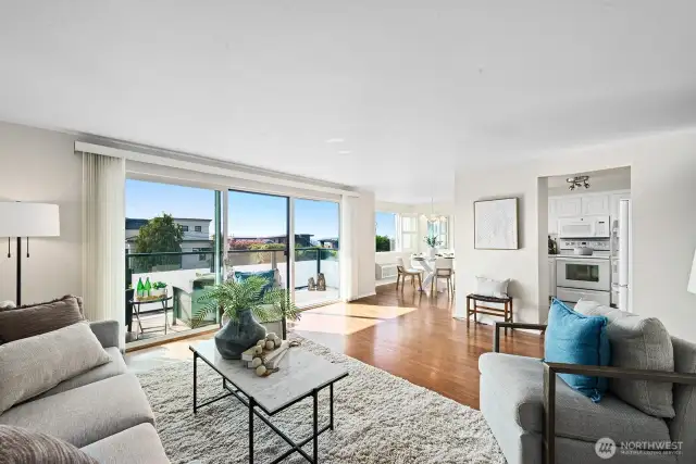 Discover this bright Shoreline condo!   A light filled living room opens to your private view deck, showcasing captivating partial view of the Sound and territory.