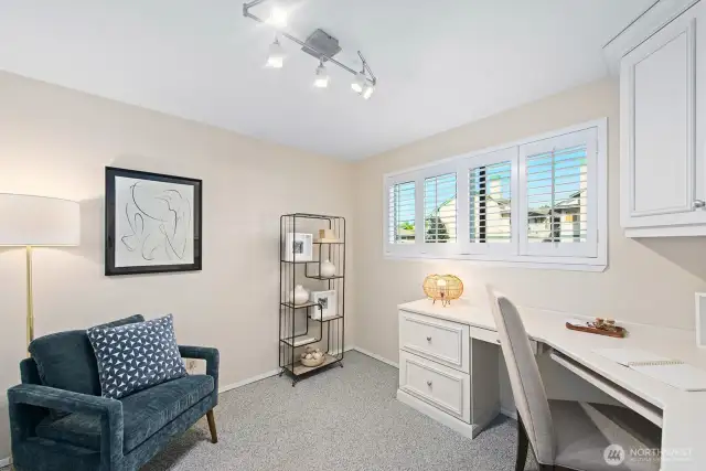 This flexible space serves as a comfortable second bedroom or ideal home office, complete with a convenient built-in desk and ample double closet storage to keep you organized.