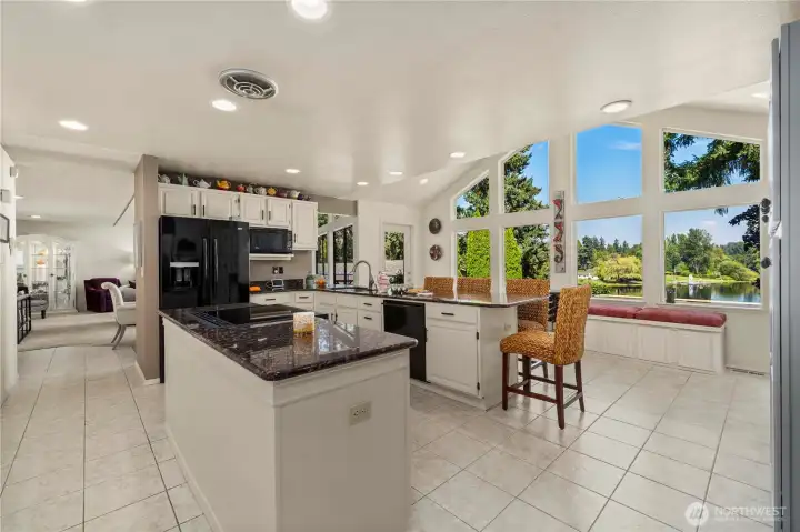 The final expansion enlarged this kitchen with a vaulted ceiling wall of windows.  This last conversion completed the home's 2867sf size.  Enjoy the abundant cabinet and counter space.