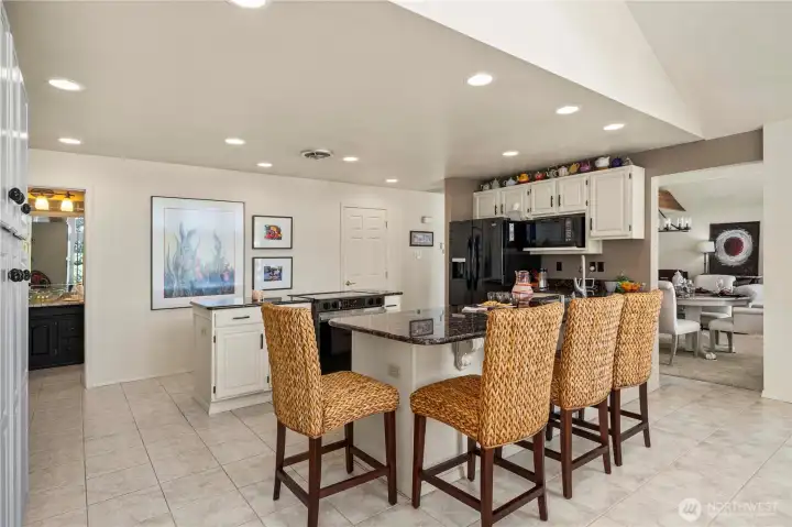 The 3.4 bath on the main level is just ahead.  Gather around the counter for less formal meals and conversation.