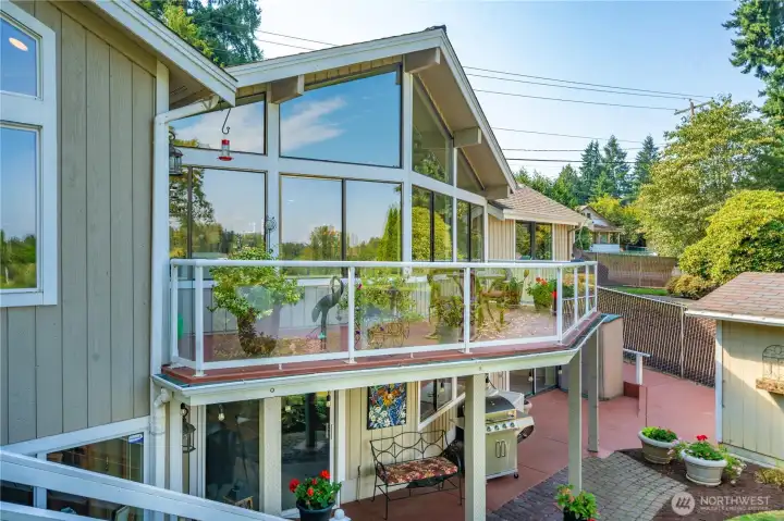 Expansive outdoor living space including weather protected BBQ area on the lower level.