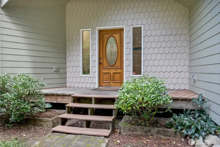 Scalloped detailed siding greets you at the entrance of this charming home.