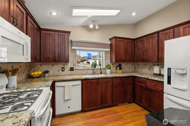 Tile backsplash, ample counter space, and a view from the sink.