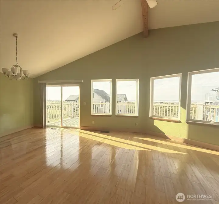 Huge living room/dining area with wall of windows showcasing the incredible ocean views