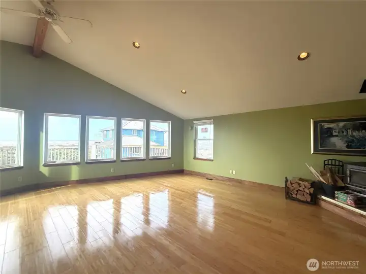 Huge living room/dining area with wall of windows showcasing the incredible ocean views