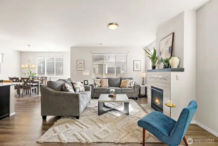 Open light and bright living room with gas fireplace.