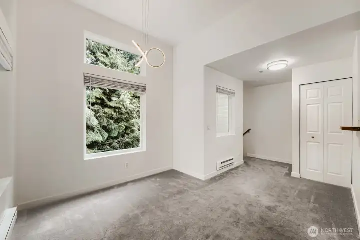 The staircase takes you from the vestibule directly into this top floor, corner unit. The dining area is to the left, coat closet and kitchen to the right.