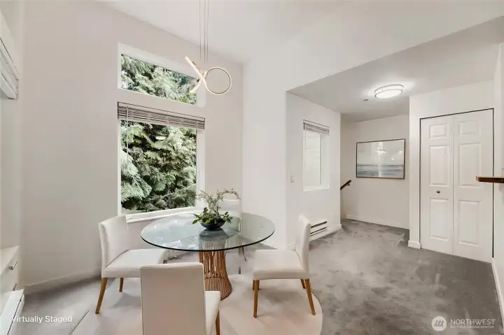 Virtually staged dining area. There is plenty of room for a large dining ensemble. The lovely trees are enjoyed through the oversized windows.
